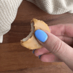 A hand holding an easy peanut butter banana bite